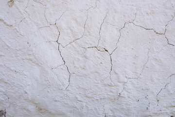Close-up of cracked white wall texture
