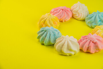 Colorful Marshmallows Arranged in a Circle on Yellow Background