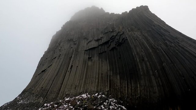 Sailing close to Edinburgh Hill South Shetland Island Antarctic Peninsula POV from boat up 180 metres up to top of basalt columns
