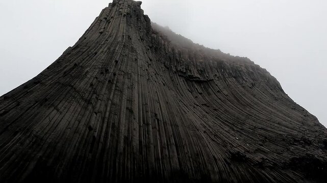Sailing close along Edinburgh Hill South Shetland Island Antarctic Peninsula POV from boat up 180 metres to top of basalt columns