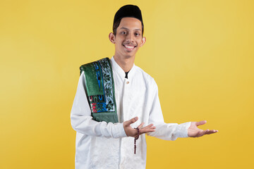 Smiling muslim man wear white shirts with Islamic ornaments, a prayer mat on the shoulder and...