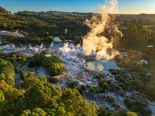 Aerial view of Wai-O-Tapu geothermal area in Rotorua, New Zealand. Steam rises from the hot springs and mud pools, a popular tourist destination.