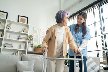Young asian caregiver or woman nurse hand on senior female shoulder give support empathy to...