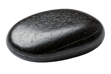 A shiny black smooth stone with a light colored line across it on a black background in a studio shot