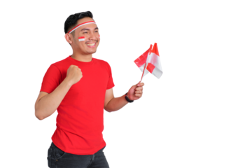 Excited young Asian man celebrating Indonesian independence day holding the Indonesian flag isolated on transparent background