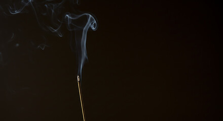 Serene incense smoke swirls gracefully against a dark background peaceful meditation moment captured