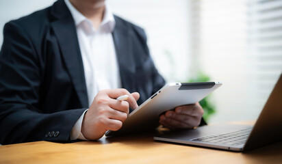 Businessman Working on Tablet with Stylus
