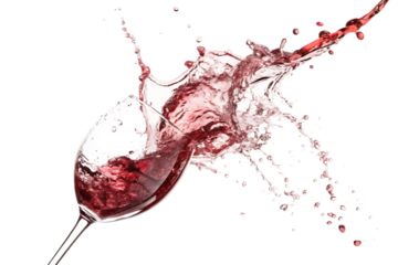 Close up of a wine glass with red wine splashing out against a black background in a dynamic motion shot