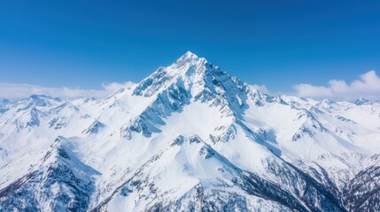 Obraz premium Majestic Snow-Capped Mountain Landscape Under Clear Blue Sky