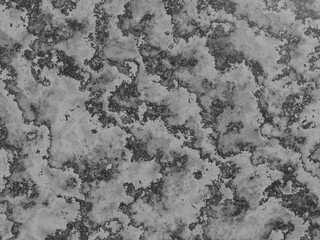 Rough, textured marble surface with distinct black and grey patterns.