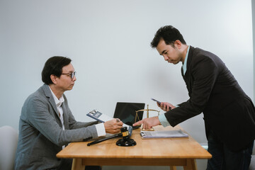 Professional lawyer advising client on legal contracts—ensuring justice, compliance, and...