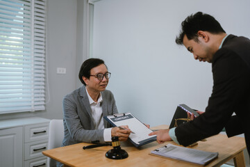 Professional lawyer advising client on legal contracts—ensuring justice, compliance, and financial protection in corporate agreements, court matters, and investments.