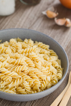 Cooked fusilli or rotini pasta served in bowl without sauce (Selective Focus, Focus one third into the image)