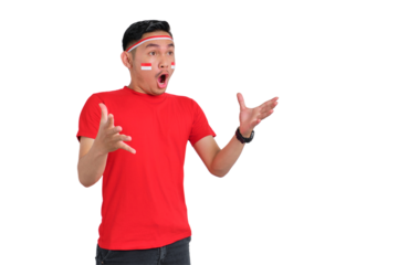 Shocked young Asian man standing with open mouth at copy space isolated on transparent background. Indonesian independence day concept