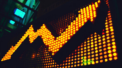 Glowing upward arrow graph on digital screen with financial charts, symbolizing stock market growth, corporate success and positive economic trends.
