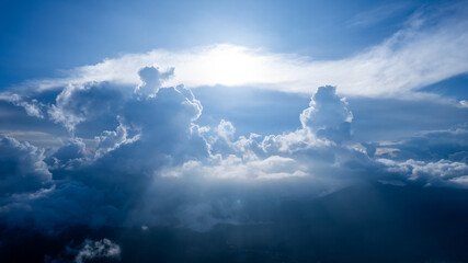 A high-altitude photo capturing towering clouds with rays of sunlight piercing through. The image evokes a sense of wonder, peace, and majesty&mdash;perfect for nature themes or inspirational use.