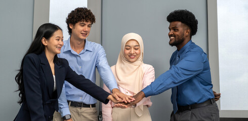 Diverse business team joining hands in unity, asian, african and muslim coworkers show teamwork and collaboration success celebration, corporate support, inclusion, office motivation, work synergy