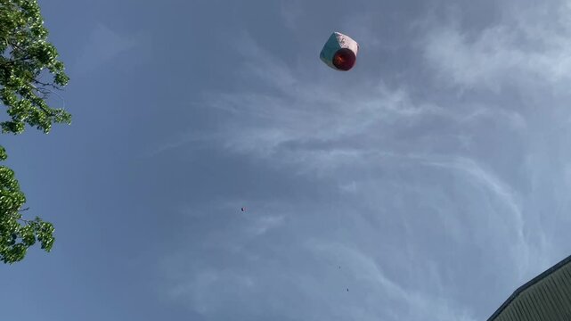 A flying lantern in the blue sky in Shifen Taipei handheld shot