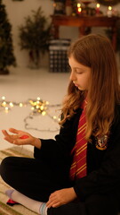 A dreamy young girl with long white hair gazes thoughtfully at a pendant in her hands. Surrounded by a magical, fairy tale atmosphere, the scene evokes a sense of wonder, mystery, and innocence. 
