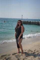 Woman in Black Dress Posing on Beach