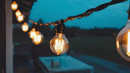 Outdoor string lights at dusk. - Powered by Adobe