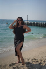 Woman in Black Dress Posing on Beach