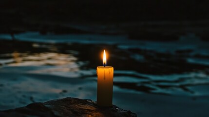 Fototapeta premium Serene Night: A Candle's Glow by the Water