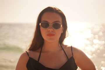 Woman in Sunglasses Posing by the Sea