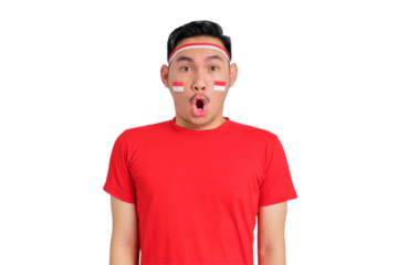 Shocked young Asian man celebrating Indonesian independence day looking at camera with open mouth isolated on transparent background