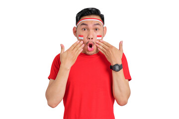 Shocked young Asian man celebrating Indonesian independence day looking at camera with open mouth isolated on transparent background
