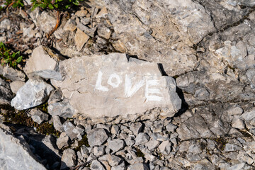 A stone with the inscription 'LOVE'.