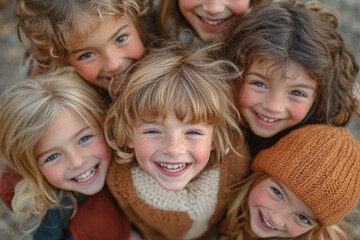 Group of smiling young girls posing for camera, arms around each other in front of colorful mural, radiating joy and friendship.