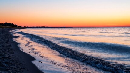 Obraz premium Sunset Over Calm Waters With Gentle Waves Lapping on Sandy Shore Near Pier Surrounded by Trees in Tranquil Evening Atmosphere