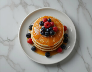 Pancakes with Fresh Berries and Syrup on White Plate