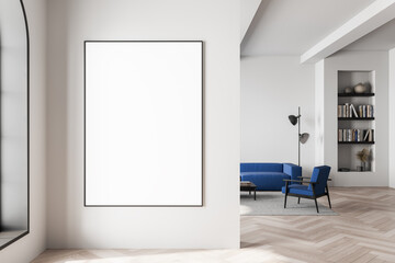 Blank framed poster mockup on clean white wall in modern interior with stylish furniture and bookshelf in soft natural lighting. 3D Rendering