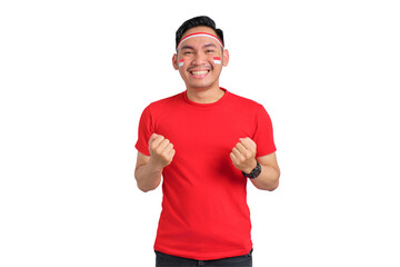 Naklejka premium Excited young Asian man celebrating Indonesian independence day standing while raising fist isolated on transparent background