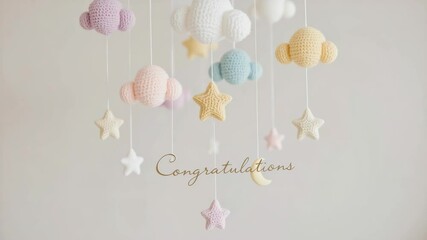 Soft pastel crochet clouds and stars mobile with "Congratulations" text, perfect for baby shower or nursery decor.