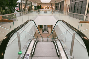 Glass-sided escalator in spacious retail mall