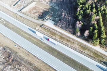 Transport truck driving on road through scenic landscape