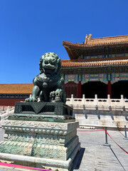Ancient chinese architecture and guardian lion statue at forbidden city in beijing