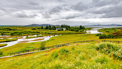 Thingvellir National Park, Iceland, Famous geological and historical site with a river stream and church, summer, South West Iceland, scenic dramatic view