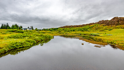 Thingvellir National Park, Iceland, Famous geological and historical site with a river stream and a church, summer, South West Iceland, scenic dramatic view