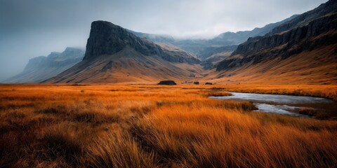Misty Cliffside Mountain Rising Above Golden Grass Hillside in Autumn Light, Dramatic Landscape with Steep Rocky Slopes, Rugged Nature Scene Evoking Solitude, Wilderness, and Majestic Elevation