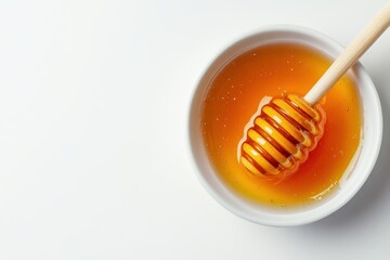 Sweet golden honey in a bowl with wooden honey dipper bee food amber thick yellow sticky natural