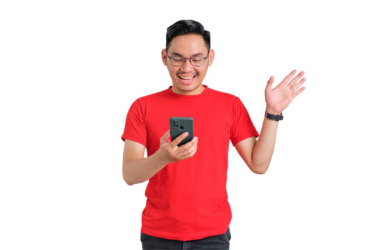 Cheerful young Asian man looking at mobile phone screen with raised hand received good news isolated on transparent background