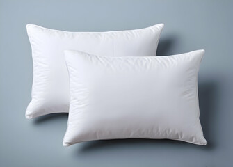 Two White Pillows on a Solid Color Background for Comfort and Sleep
