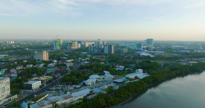 Aerial view of areas along Iloilo River with iloilo rising business areas at the background