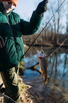 Boy holding up rainbow trout during spring season