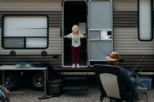 Smiling Child Stands in RV Doorway