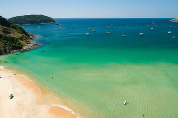 Obraz premium Aerial view of a blue sea surface water texture background and sun reflections Aerial flying drone view Waves water surface texture on sunny tropical ocean in Phuket island Thailand